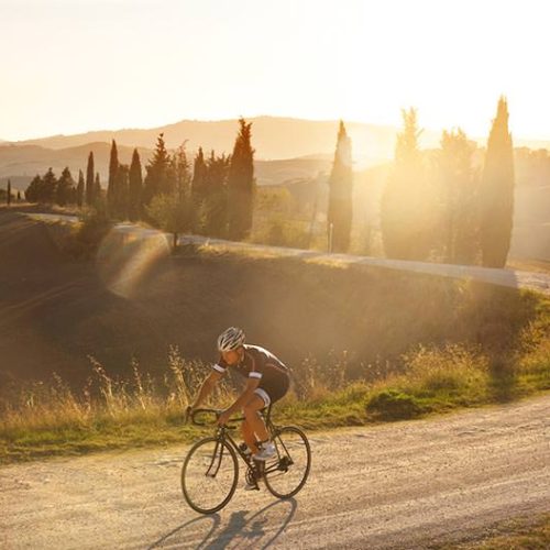 AQTO-Cycling-a-rider-onthe-gravel-at-sunset